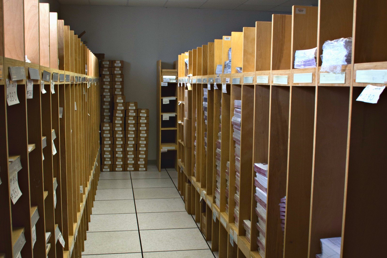 An aisle of storage racking holding customers' printed inventory at Broudy Printing