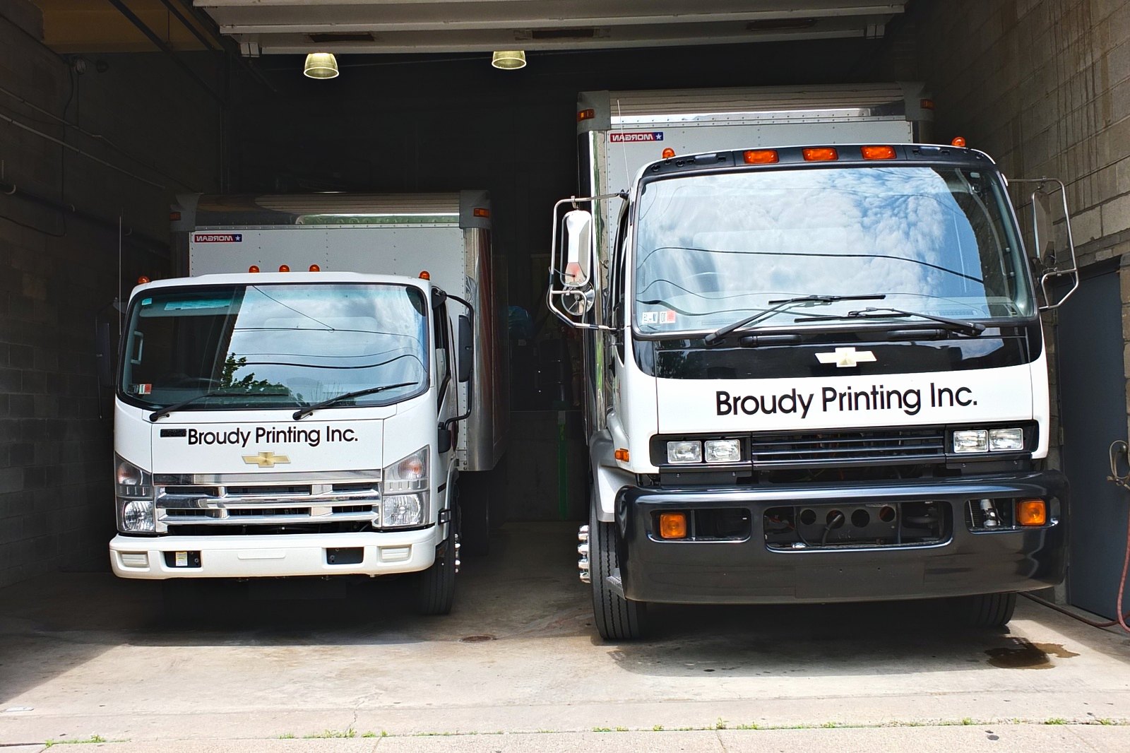 Broudy Printing's two delivery trucks in the loading bay at 221 Auburn Street