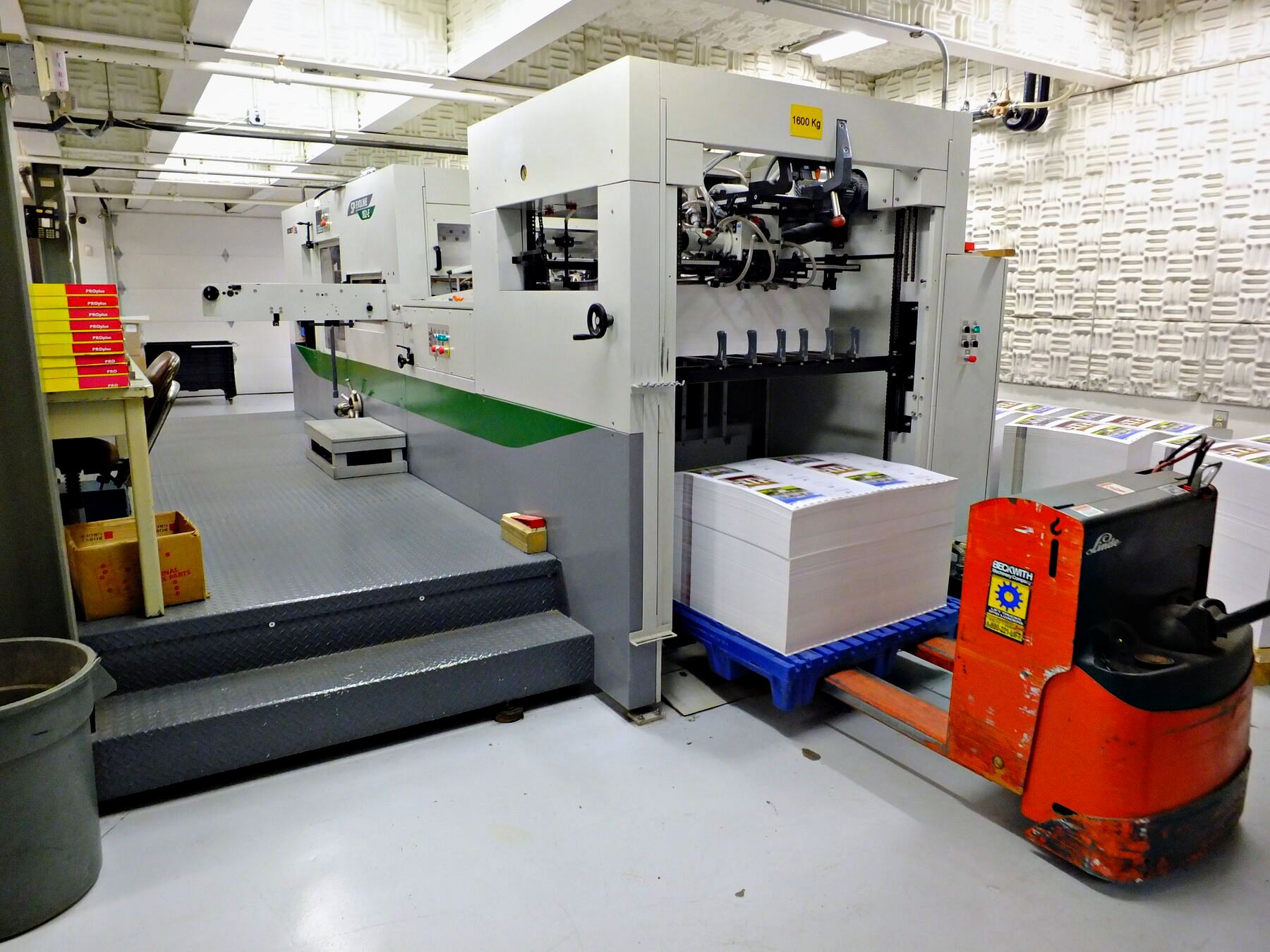 A press sheet being checked on the pressroom floor at Broudy Printing